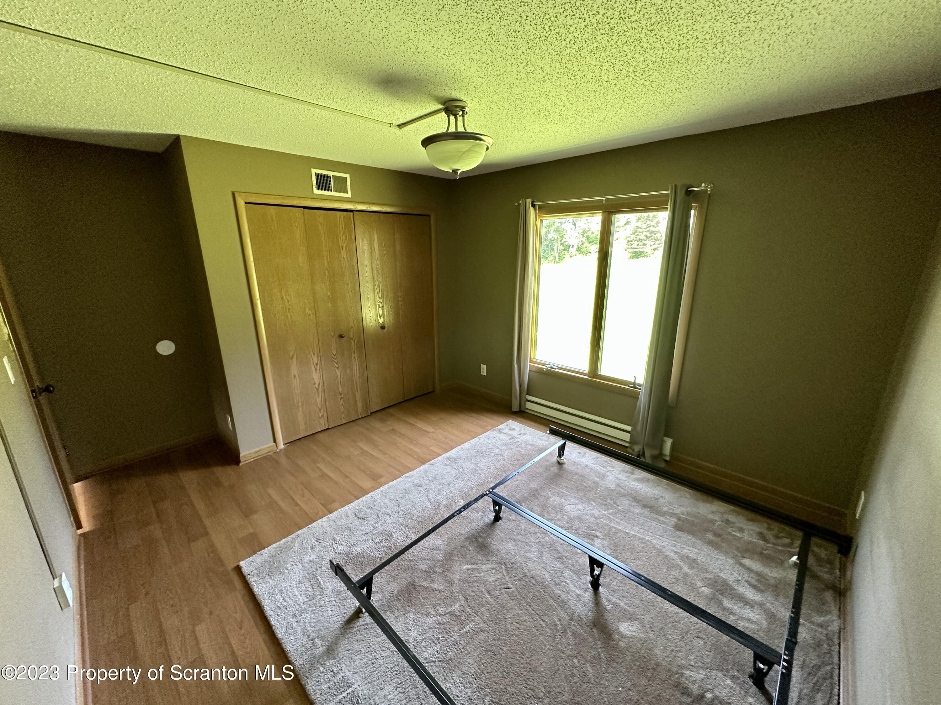 764 Coon Road Wyoming, PA 18644 - Photo 9 of 23 a view of an empty room and window