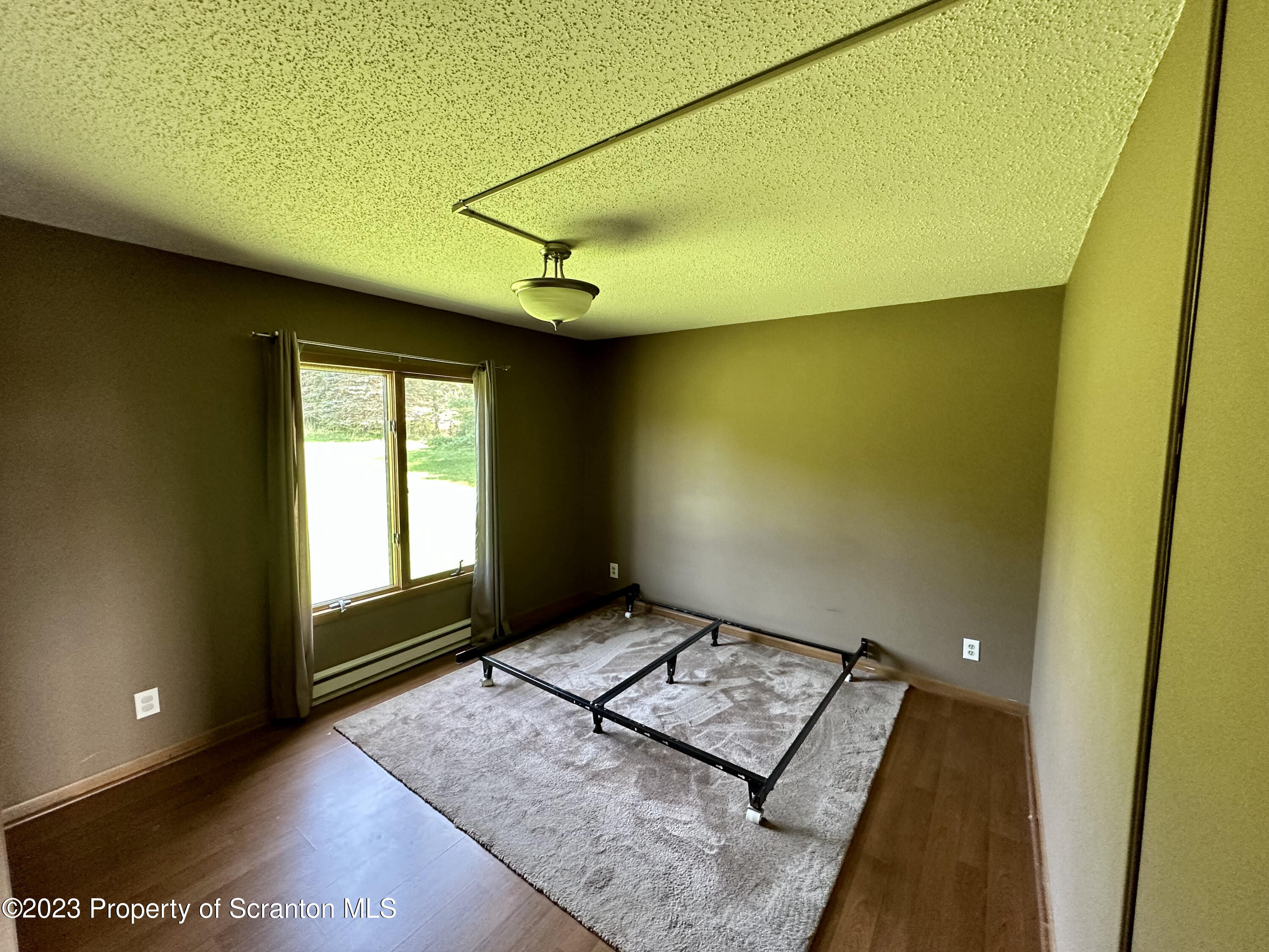 764 Coon Road Wyoming, PA 18644 - Photo 10 of 23 a view of an empty room and window