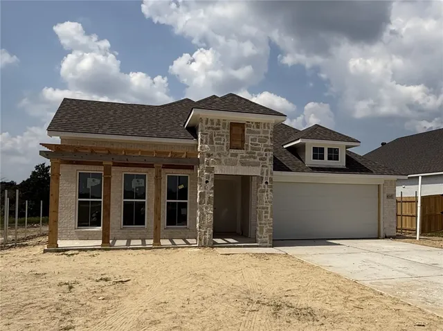 front view of a house with a garden