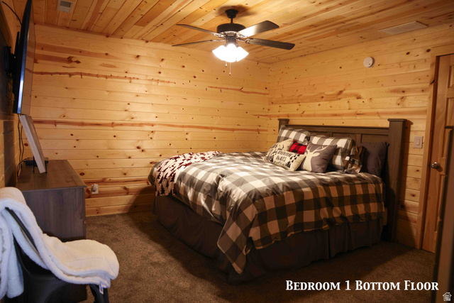 15253 Mill Road, Unit 62 Huntsville, UT 84317 - Photo 3 of 48 Bedroom featuring natural wood paneling on walls and ceiling, dark brown carpet flooring, and a ceiling fan with integrated lighting