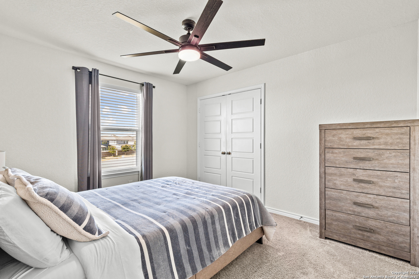 5205 Nature Marion, TX 78124 - Photo 23 of 45 a bedroom with a bed and a ceiling fan