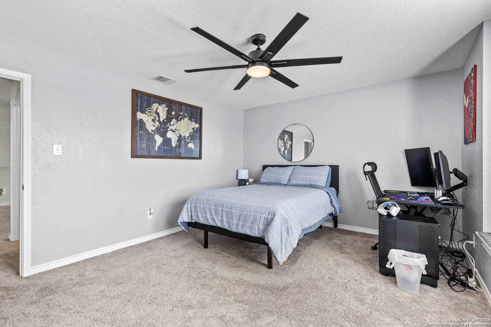 5205 Nature Marion, TX 78124 - Photo 33 of 45 a spacious bedroom with a bed and a ceiling fan