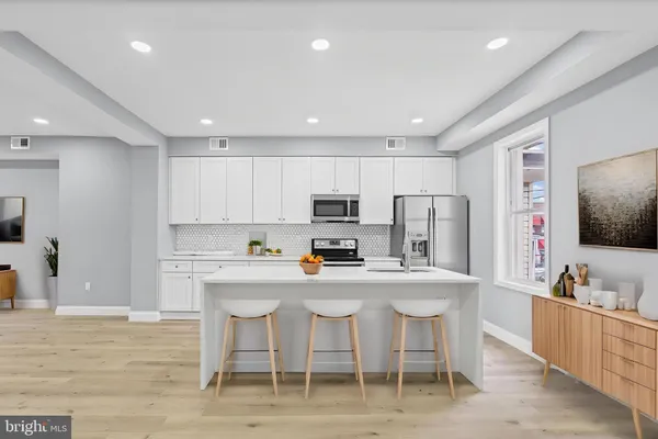 a bedroom with a large bed and potted plant