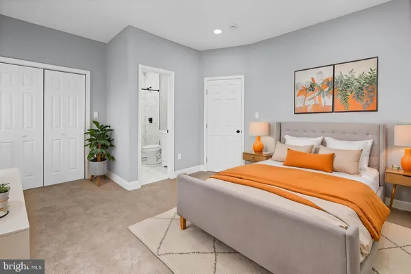 a bedroom with a bed and a couch