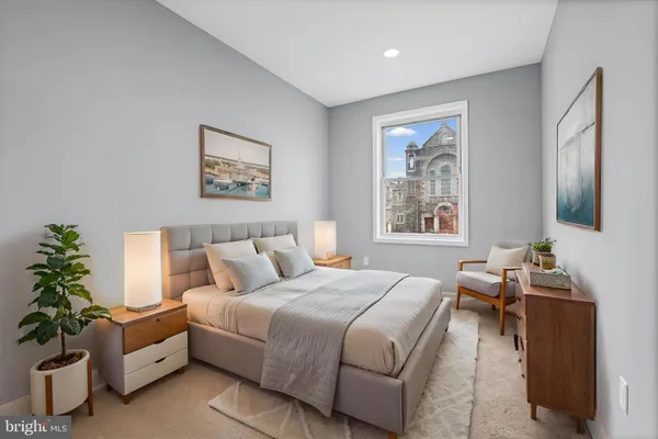 a bedroom with a bed and a couch