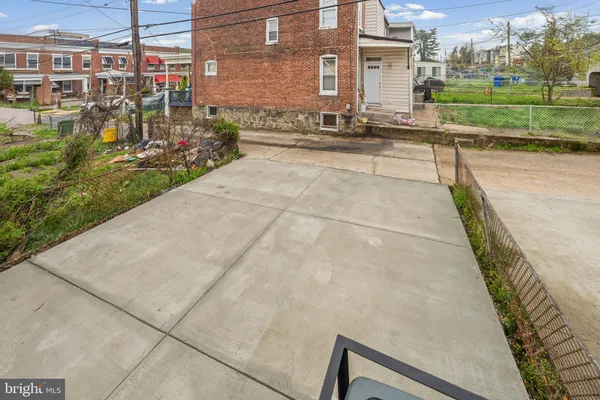 a view of a house with a yard and large trees