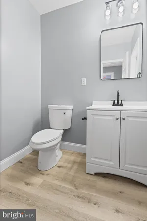 a white toilet sitting next to a bathroom sink