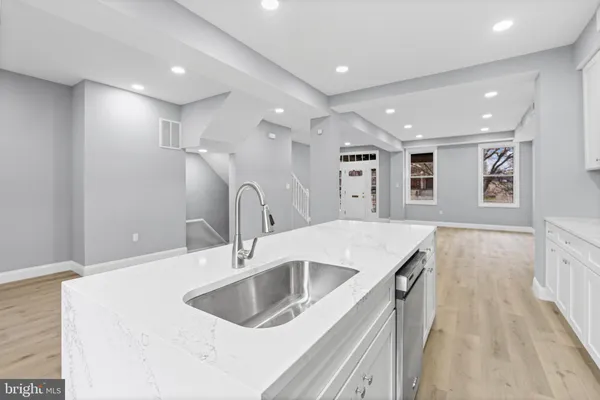 a kitchen with a sink and a refrigerator