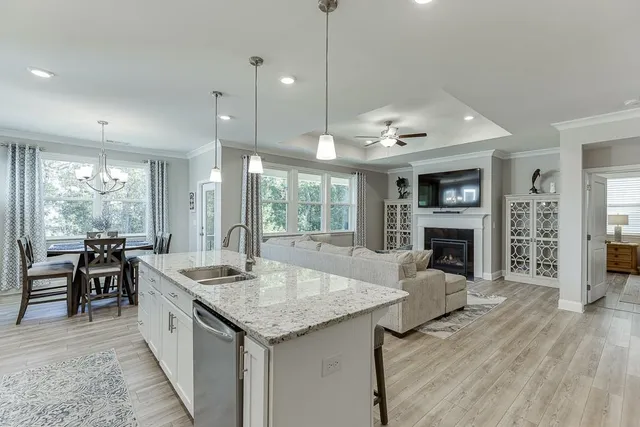 a bedroom with a bed and a lamp on the dresser