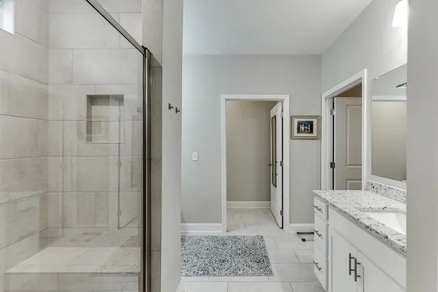 a kitchen with granite countertop a sink a counter space appliances and cabinets