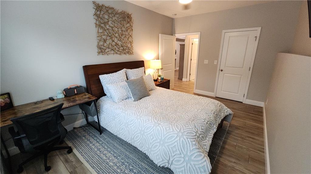 5188 Watchmans Cove Gainesville, GA 30504 - Photo 55 of 90 a bedroom with a bed and wooden floor
