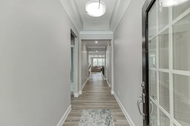 a kitchen with stainless steel appliances granite countertop a dining table and chairs