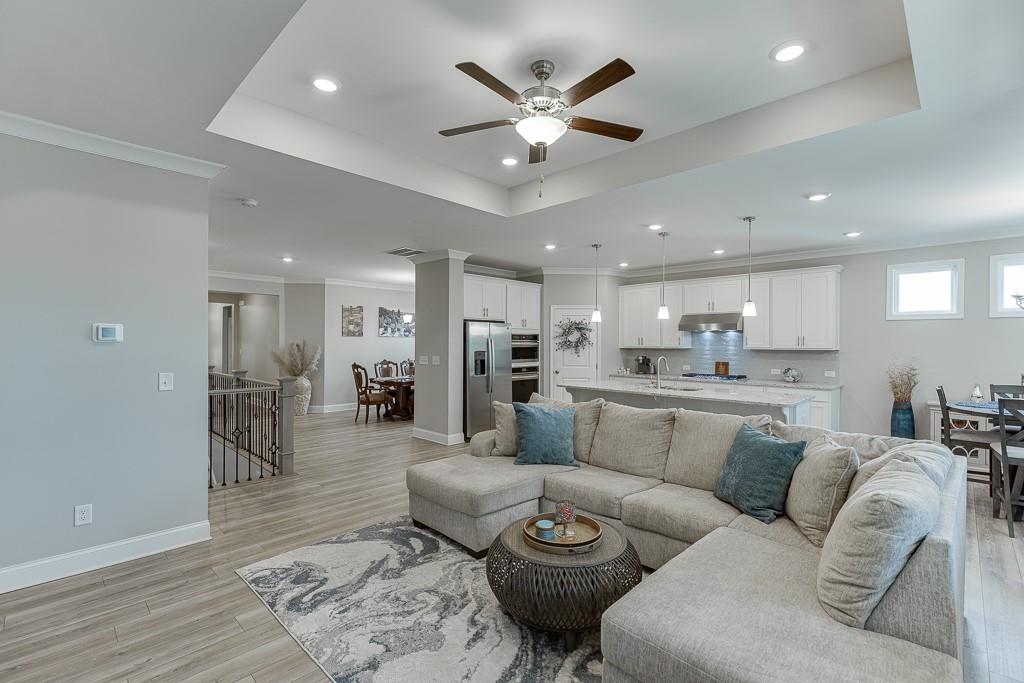 5188 Watchmans Cove Gainesville, GA 30504 - Photo 8 of 90 a living room with furniture kitchen view and a wooden floor