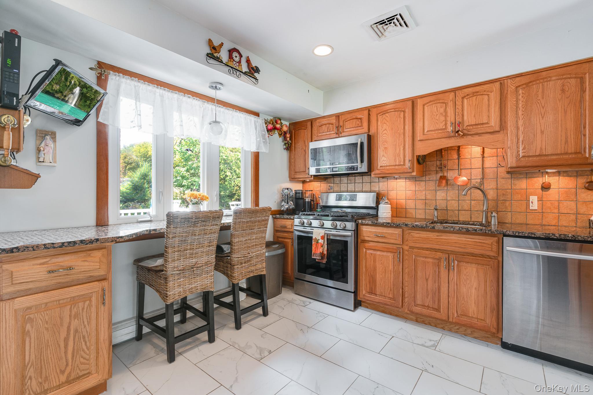 34 Raker Road Poughkeepsie, NY 12603 - Photo 8 of 27 a kitchen with stainless steel appliances granite countertop sink stove top oven table and chairs
