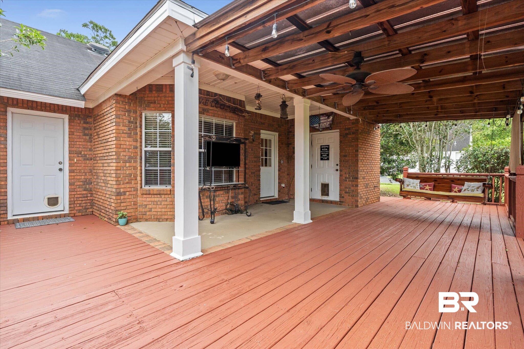 3170 Scott Dairy Loop Road West Mobile, AL 36695 - Photo 19 of 24 Spacious outdoor patio area featuring a stained wood deck, a covered section with exposed wood beams, and a ceiling fan