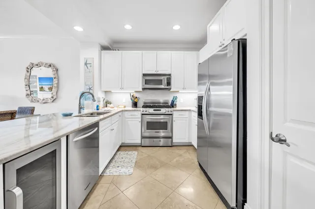 a kitchen with stainless steel appliances kitchen island granite countertop a sink and cabinets