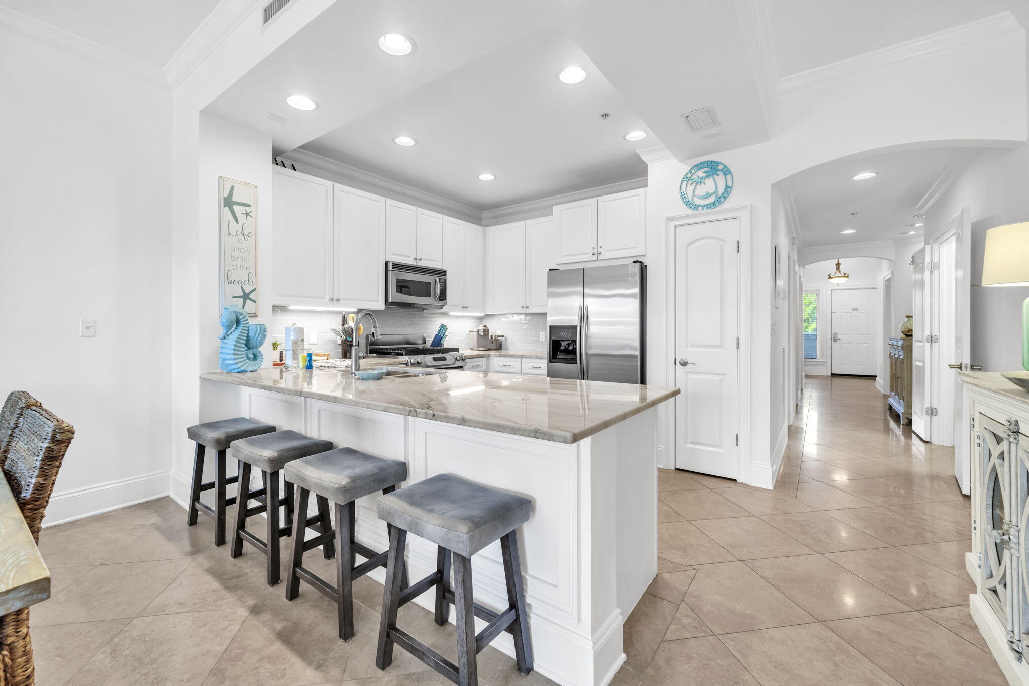 2421 West County Highway 30A, Unit F304 Santa Rosa Beach, FL 32459 - Photo 19 of 63 a kitchen with stainless steel appliances kitchen island granite countertop a refrigerator and a stove top oven