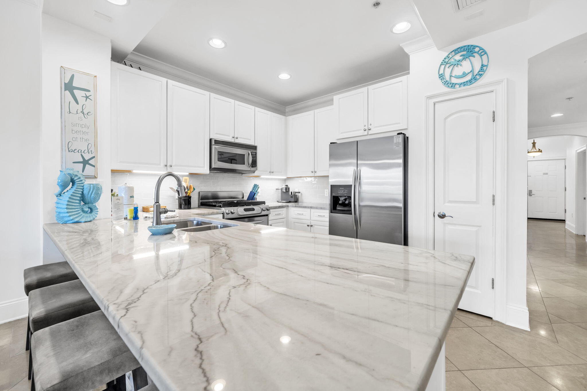 2421 West County Highway 30A, Unit F304 Santa Rosa Beach, FL 32459 - Photo 20 of 63 a kitchen with stainless steel appliances granite countertop a stove refrigerator sink and cabinets