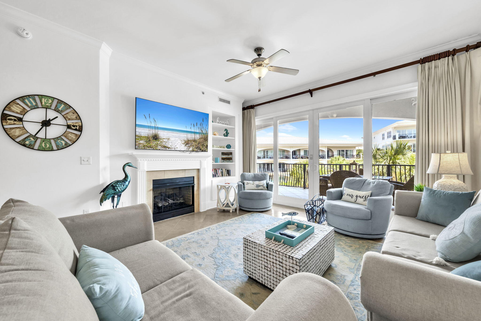 2421 West County Highway 30A, Unit F304 Santa Rosa Beach, FL 32459 - Photo 22 of 63 a living room with furniture a fireplace and a large window