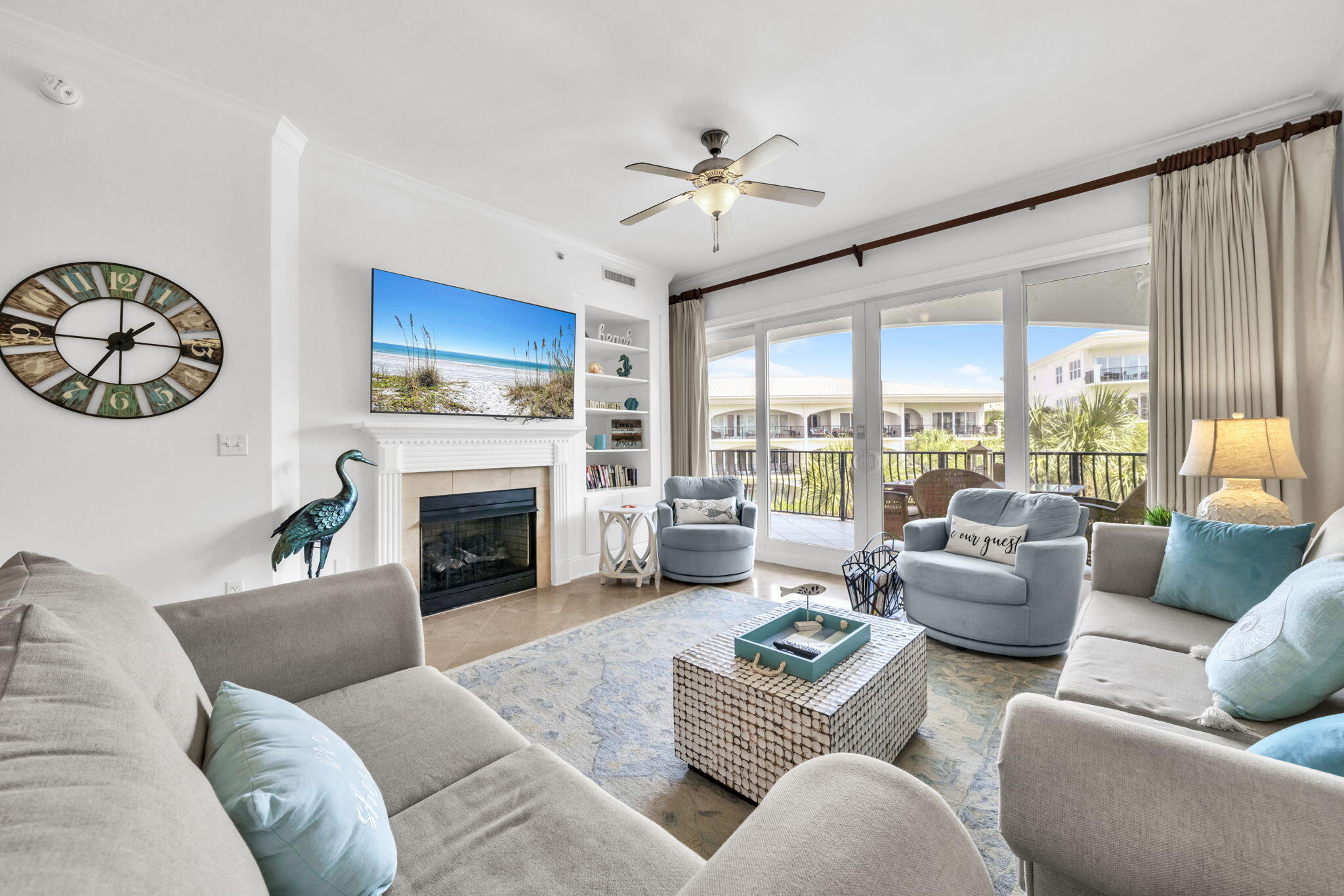 2421 West County Highway 30A, Unit F304 Santa Rosa Beach, FL 32459 - Photo 23 of 63 a living room with furniture a fireplace and a large window