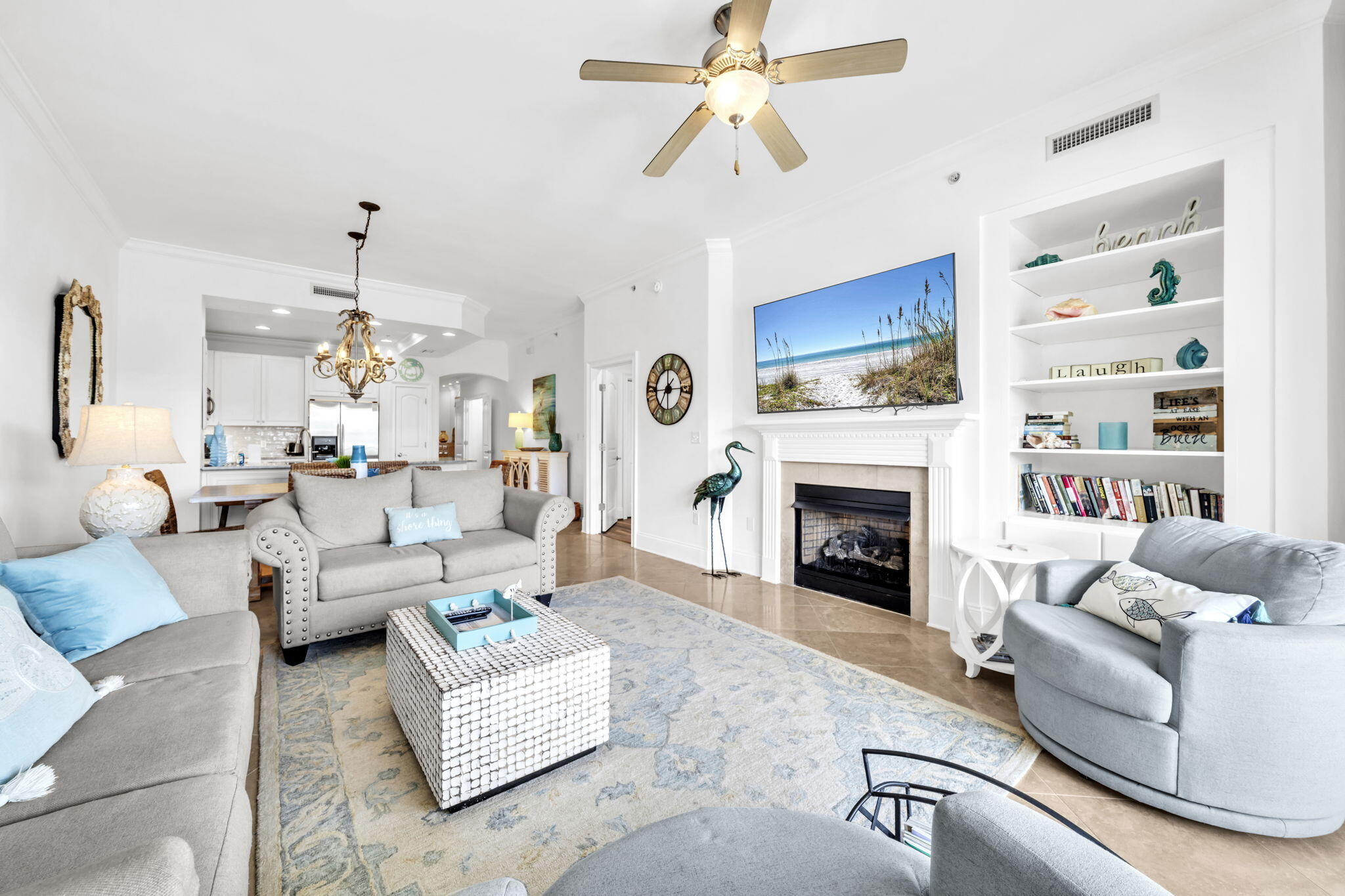2421 West County Highway 30A, Unit F304 Santa Rosa Beach, FL 32459 - Photo 25 of 63 a living room with furniture a fireplace and a chandelier