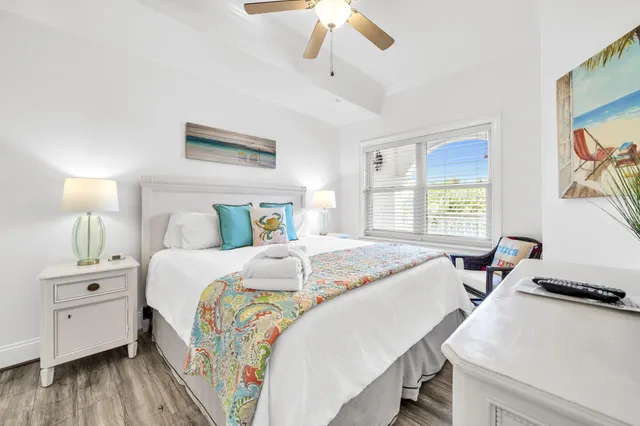 a bedroom with a bed and a painting on the wall