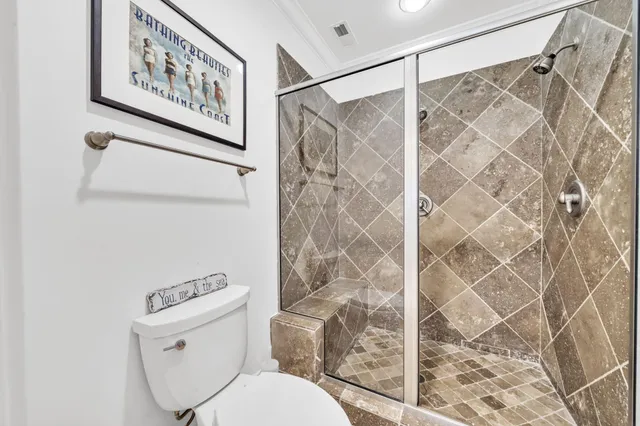 a living room with furniture and floor to ceiling windows
