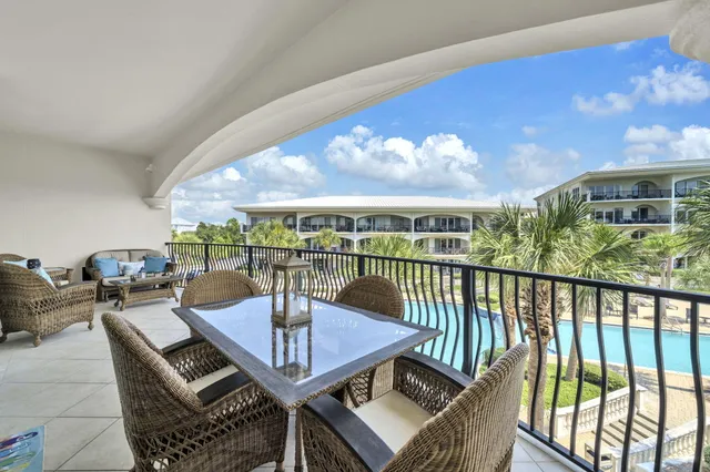 a view of a swimming pool with an outdoor seating and a yard