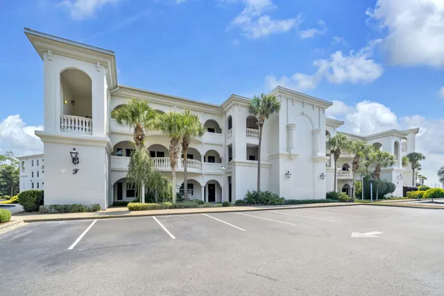 a view of a swimming pool with outdoor seating