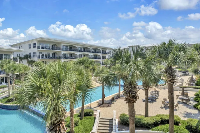 a swimming pool view with a outdoor seating