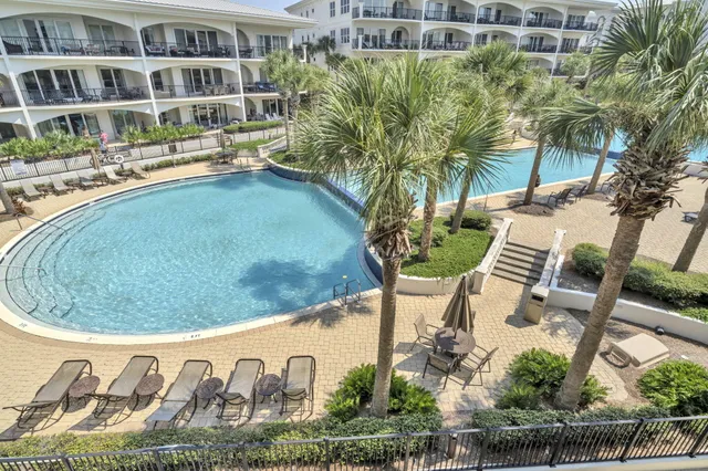 a view of a building with a swimming pool and a yard
