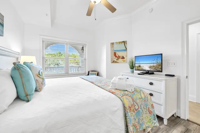 a bedroom with bed and flat screen tv