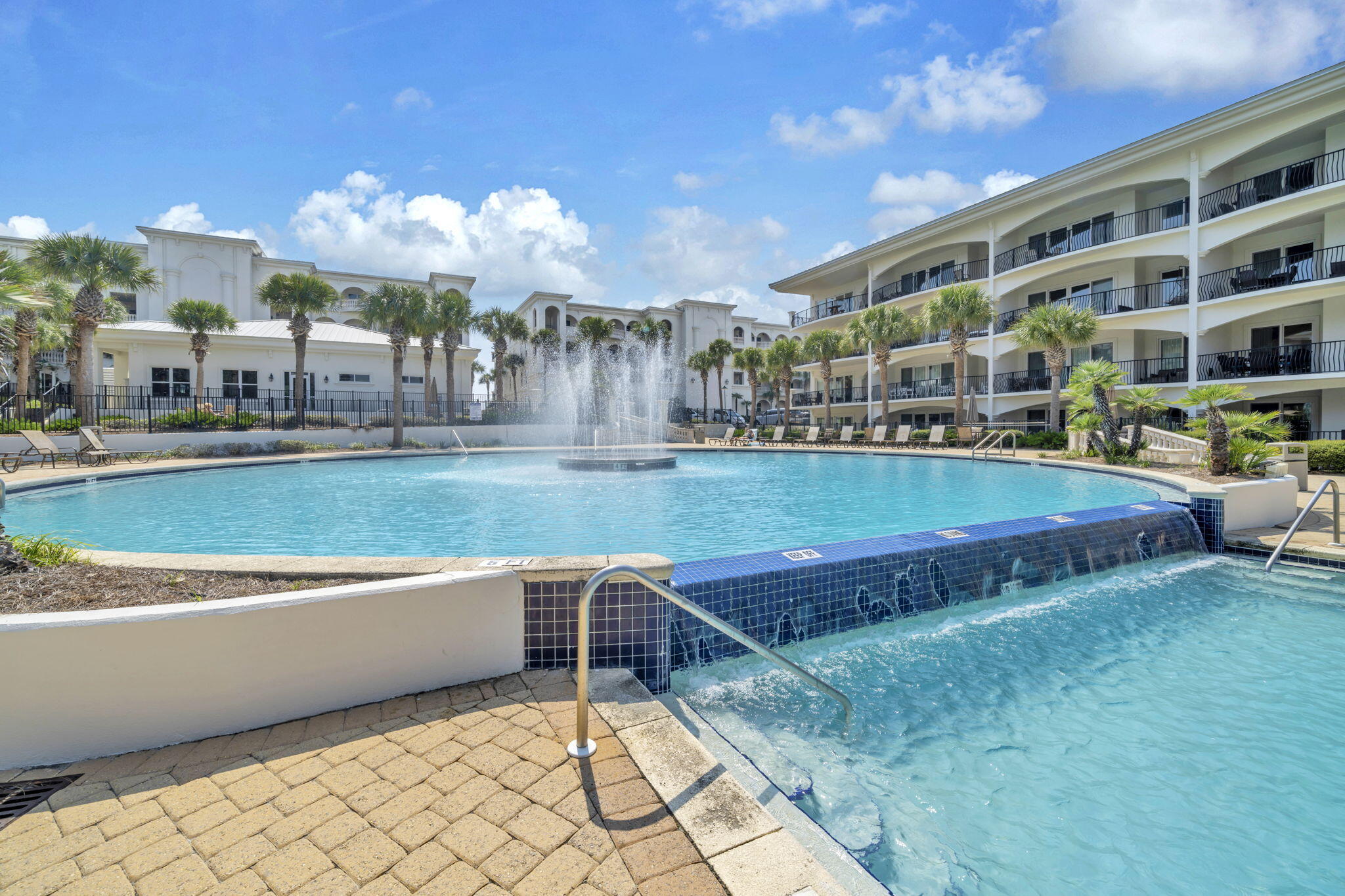 2421 West County Highway 30A, Unit F304 Santa Rosa Beach, FL 32459 - Photo 47 of 63 a view of a building with a swimming pool and a yard