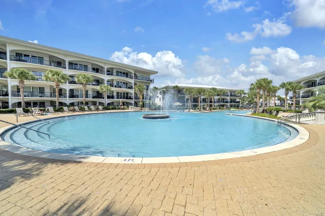 a view of a lake with couches chairs