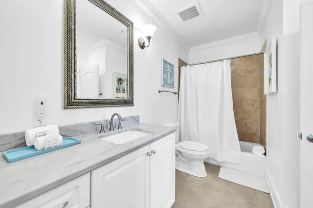 a bathroom with a double vanity sink mirror and toilet