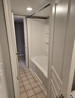 a bathroom with a tub and shower