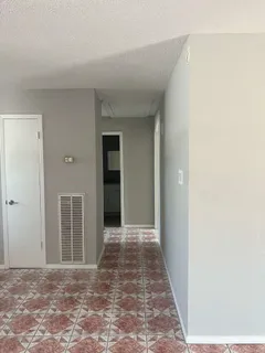 a view of hallway with wooden floor