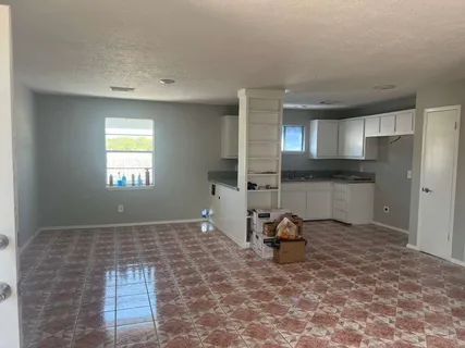 a view of a kitchen with a sink and cabinets