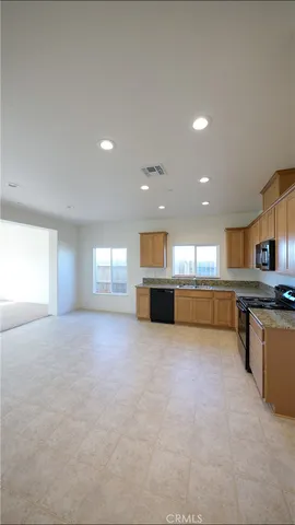 a view of kitchen with kitchen island and windows