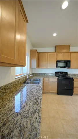 a kitchen with stainless steel appliances granite countertop a stove a sink and a granite counter tops
