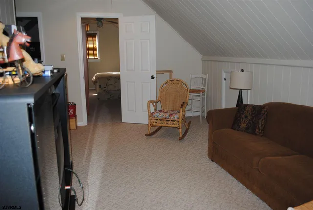 a living room with furniture a couch and a flat screen tv