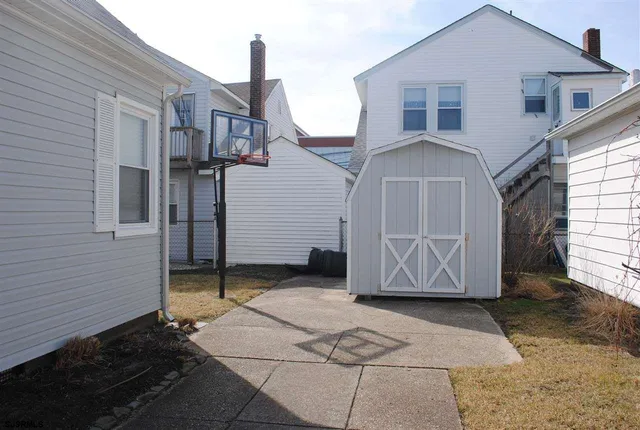 a view of a grey house with a yard