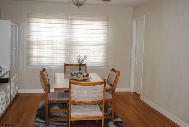 a view of a dining room with furniture and window