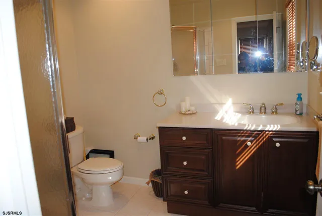 a bathroom with a sink vanity and toilet
