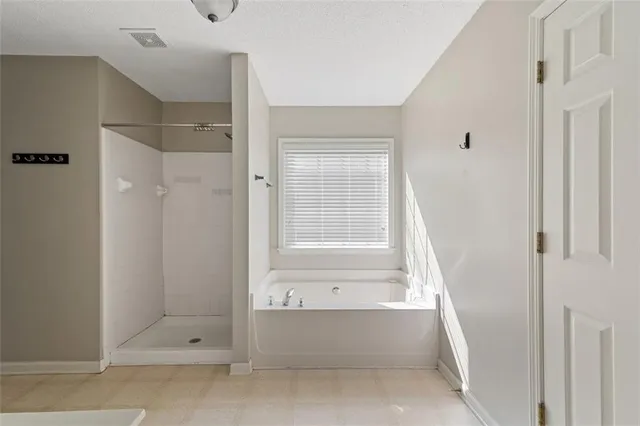 a bathroom with a bathtub and shower
