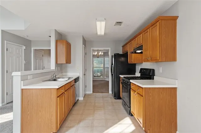 a kitchen with a sink stove and refrigerator