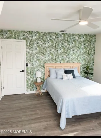 a bedroom with a bed and a wooden floor