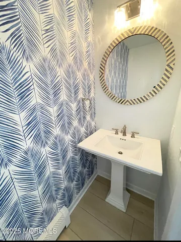 a bathroom with a sink a mirror and vanity