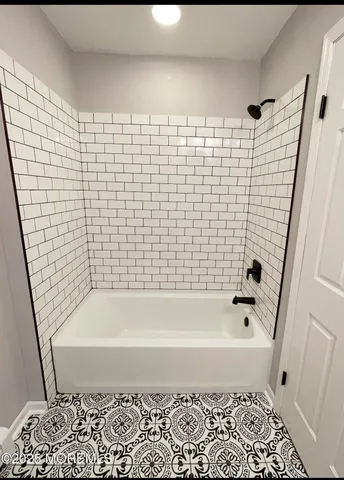 a bathroom with a bathtub and shower