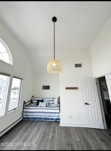 a view of a bedroom with furniture and window